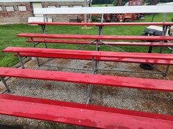 Apply overcoat of paint on red bleachers at Freedom Field - $50 Value